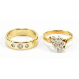 A 9ct yellow gold three stone diamond set ring, size M 1/2, and a 9ct yellow gold dress ring, size