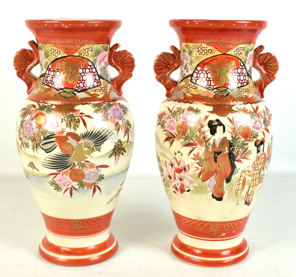 A pair of Japanese Kutani twin handled baluster vases decorated with figures, flowers and birds,
