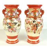 A pair of Japanese Kutani twin handled baluster vases decorated with figures, flowers and birds,