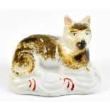 A 19th century Staffordshire model of a recumbent cat, length 9cm.