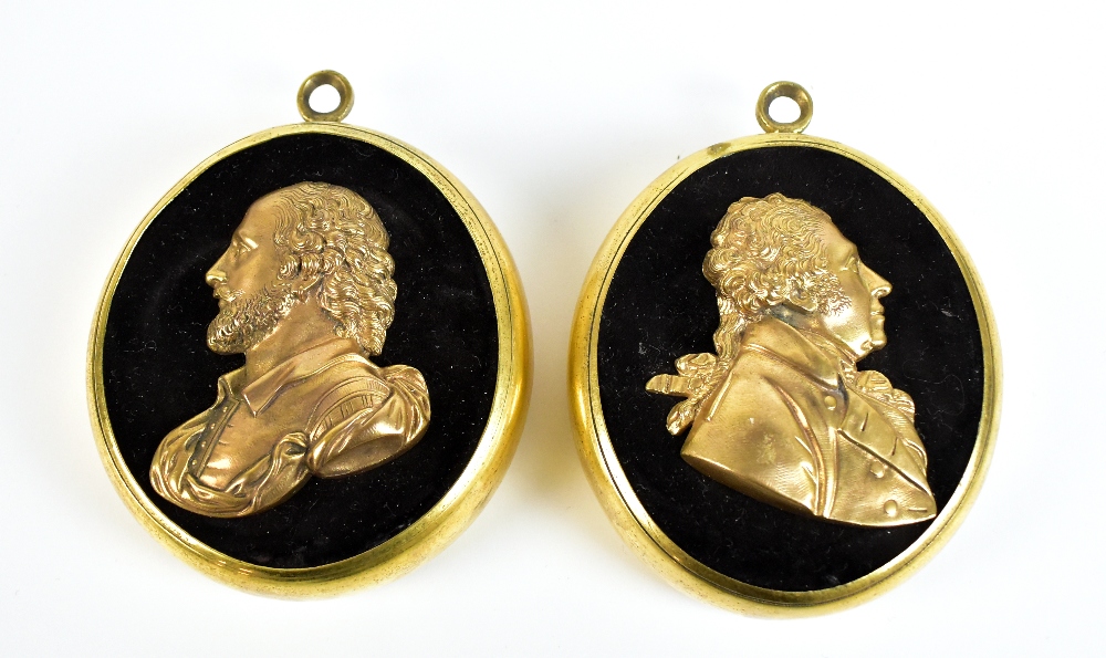 A pair of 19th century profile busts set in oval brass frames, the first depicting William