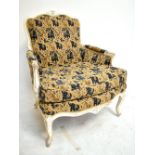 A French cream and gilt painted fauteuil with yellow and navy upholstery on cabriole legs.