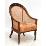 A 19th century stained beech framed bergère armchair terminating on brass castors, height 91cm,