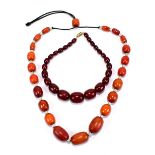 A graduated cherry amber coloured bead necklace (36.9g), length approx 30cm, and a further bead