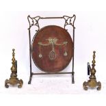 A brass Art Nouveau framed fire screen with later copper panel insert and a pair of andirons (3).