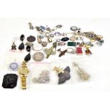 A small group of costume jewellery to include silver earrings, brooches, and a small group of badges