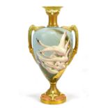 CHARLES BALDWYN FOR ROYAL WORCESTER; a twin handled pedestal urn vase hand painted with swans in