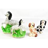 A 19th century Staffordshire figure of a zebra, height 21cm, another similar figure, height 16cm,