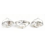 A J ZIMMERMAN LTD; a pair of George V hallmarked silver baskets with crimped rims and fixed handles,