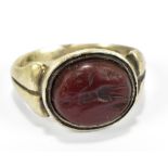 A Roman silver thumb ring with carved red stone intaglio featuring single figure, size S, approx
