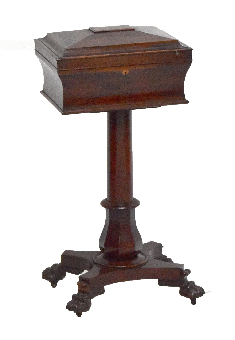 A Victorian mahogany teapoy with hinged cover enclosing fitted interior on column terminating in