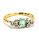 An 18ct yellow gold diamond and green stone ring, size N, approx 2.8g.