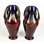 A pair of Belgian art pottery vases, each with four loop handles, height 32cm, and a smaller pair of