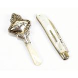 A mother of pearl bodied silver bladed pocket knife and a silver rattle inscribed 'Baby' and with