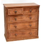 A late Victorian pine chest of two over three drawers with inlaid detail and applied brass detail to
