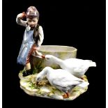 MEISSEN; a late 19th century figure of a young boy with two geese beside a water bath, blue