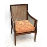 A late 19th century mahogany framed bergère gentleman's library chair on brass castors.Additional
