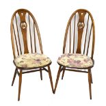 ERCOL; a set of four medium elm swan back dining chairs.