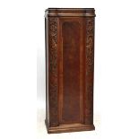 An Austrian carved walnut and crossbanded wardrobe with single carved and panelled cupboard door,