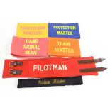 Five railway armbands comprising a cloth 'Pilotman', a 'Train Master', a rubber backed canvas '