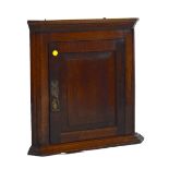 A reproduction oak flat fronted hanging corner cupboard.