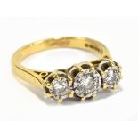 An 18ct yellow gold three stone diamond ring, the illusion set diamonds weighing a total of approx