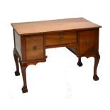 A reproduction mahogany knee hole three drawer dressing table, width 108cm.