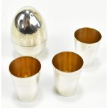 A Continental white metal tot cups and egg shaped holder, stamped 'Silver 1000', approx 3.2ozt/