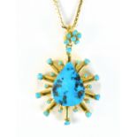 An 18ct yellow gold and turquoise starburst pendant stamped 750 to bale, length 5.5cm, on a 9ct