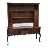 A late 18th century Shropshire oak dresser, the boarded upper section with three drawers flanked