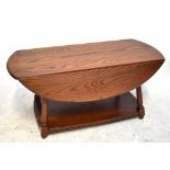 ERCOL; a medium elm drop leaf coffee table with magazine undertier shelf, length 104cm.