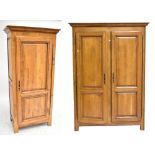 A reproduction oak twin door wardrobe and a similar smaller example, height of tallest 208cm.