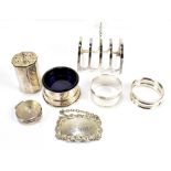 A group of variously hallmarked silver items to include a toast rack, napkin rings, mustard pot,