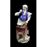 MEISSEN; a 19th century figure of a street cook based on the 18th century original, painted blue