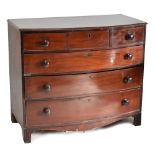 An early 19th century mahogany bowfronted chest with three short above three long graduated ebony