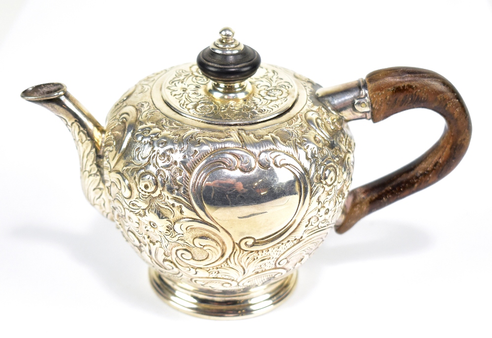 RICHARD FREEMAN; a rare George II English provincial bullet shaped teapot with later floral embossed