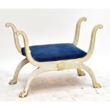 A cream painted French Empire-style stool with blue upholstered seat on carved paw feet, 69 x 94cm.