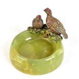 An Art Deco Austrian cold painted bronze and green onyx ashtray decorated with two grouse,