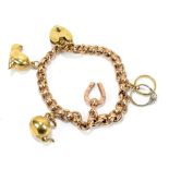 A 9ct yellow gold charm bracelet suspending predominately unmarked charms with heart shaped