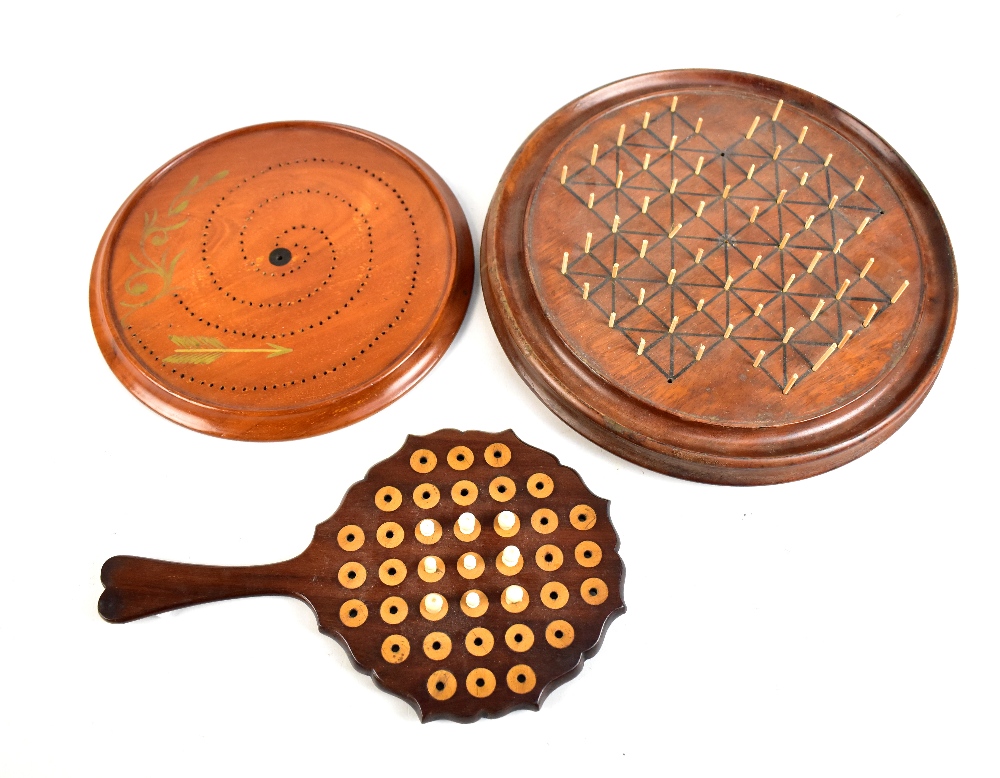 A Victorian rosewood games board with various pegs, length 24cm, and two circular games boards (3).