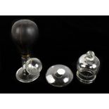 A clear glass breast pump, a clear glass cupping cup and a clear glass nipple guard (3).Additional