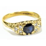 An 18ct yellow gold sapphire and diamond ring in scrolling setting, size N, approx 3.5g.