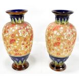 DOULTON; a large pair of Slater's Patent floral decorated baluster vases with flared rims on