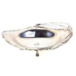 A George V hallmarked silver oval dish with swing handle, with pierced scrolling edge, maker's marks