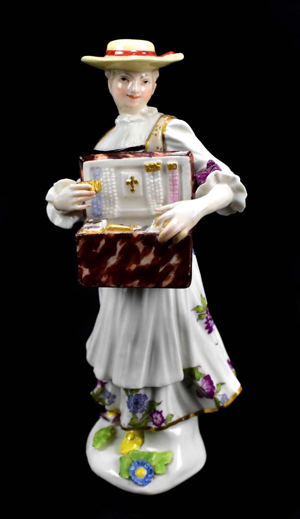 MEISSEN; a mid-18th century figure of the Trinket Seller modelled by P. Reinicke circa 1745-48,