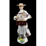 MEISSEN; a mid-18th century figure of the Trinket Seller modelled by P. Reinicke circa 1745-48,