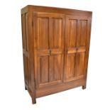 A large French 19th century walnut wardrobe with moulded dentil cornice above twin panelled doors,