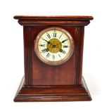 An early 20th century mahogany mantel clock, the circular dial set with Roman numerals and with