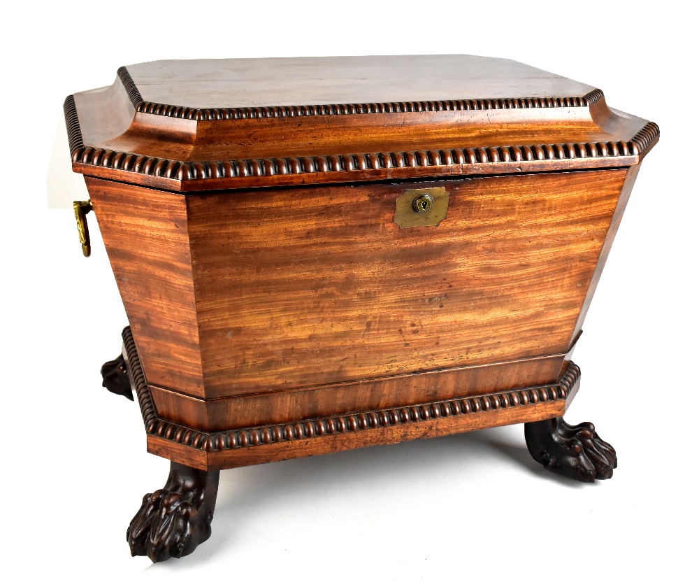 An early 19th century Irish mahogany cellarette of rectangular form with canted corners, gadrooned