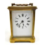 An early 20th century brass carriage clock, the white enamel dial set with Roman numerals, swing